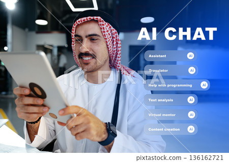 Man uses tablet to engage in AI chat and explore various features at a modern workspace 136162721