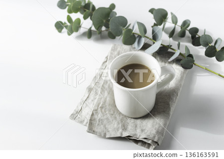 Eucalyptus and coffee on linen (white background, blank space) Eucalyptus and coffee on linen (white background, blank space) 136163591