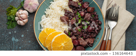 Feijoada, traditional brazilian stew with black beans, rice, and orange slices, top view Feijoada, traditional brazilian stew with black beans, rice, and orange slices, top view 136164643