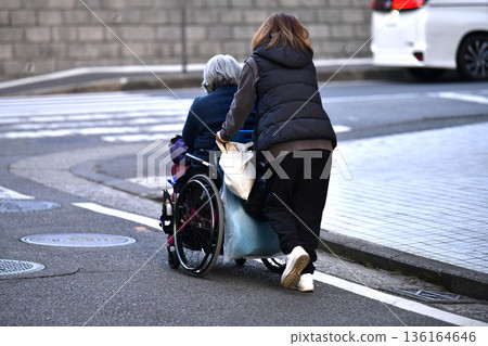 Yokohama cityscape in Japan: Steps and unevenness... Aging society: Elderly woman in wheelchair (no markings) has a hard time pushing... = Yokohama city 136164646