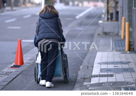 Yokohama cityscape in Japan: Steps and unevenness... Aging society: Elderly woman in wheelchair (no markings) has a hard time pushing... = Yokohama city Yokohama cityscape in Japan: Steps and unevenness... Aging society: Elderly woman in wheelchair (no markings) has a hard time pushing... = Yokohama city 136164649