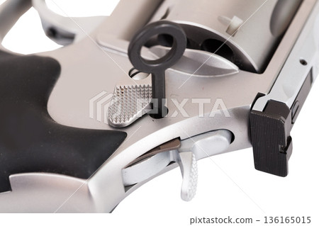 Close-up of revolver with safety lock key inserted Close-up of revolver with safety lock key inserted 136165015