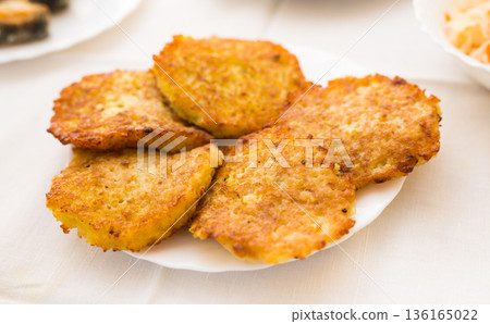Potato pancakes with sour cream on white plate 136165022
