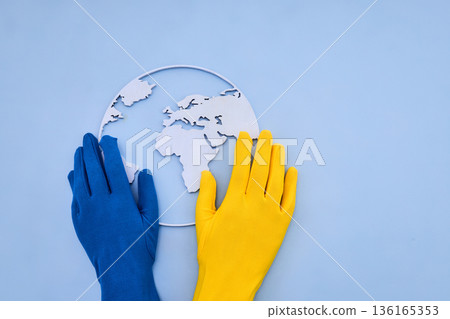 Ukraine flag colors hands holding world map Ukraine flag colors hands holding world map 136165353