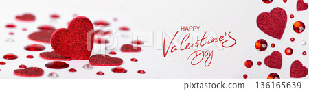 Valentines Day concept with red glitter hearts and sparkling decorative gems on a white background. Romantic Valentines Day banner template with copy space for design use. Valentines Day concept with red glitter hearts and sparkling decorative gems on a white background. Romantic Valentines Day banner template with copy space for design use. 136165639