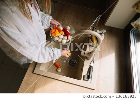 Preparing fresh vegetables in a kitchen sink for a healthy meal 136165925