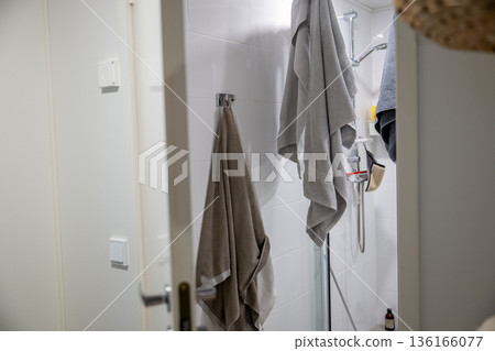 Minimal bathroom interior with towels hanging in modern shower Minimal bathroom interior with towels hanging in modern shower 136166077
