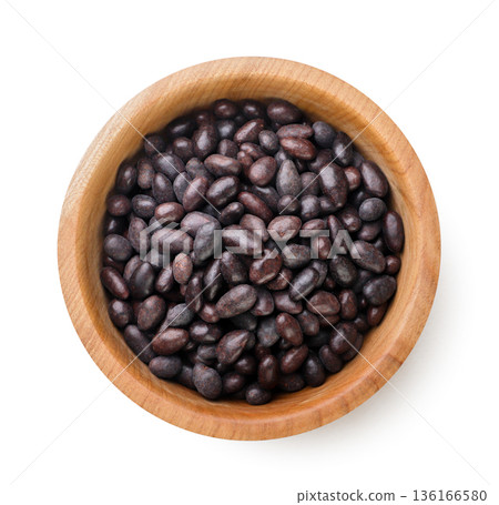 Sunflower seeds in chocolate in a wooden plate on a white background. Top view Sunflower seeds in chocolate in a wooden plate on a white background. Top view 136166580
