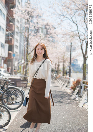 A woman traveling alone during cherry blossom season A woman traveling alone during cherry blossom season 136166671