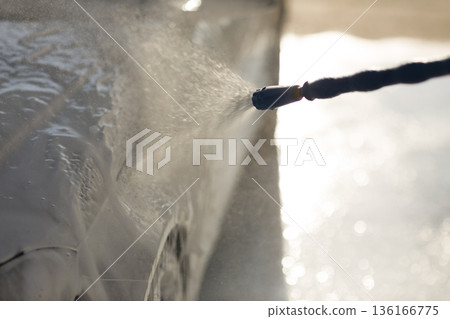 Worker washing car at self-service car wash Worker washing car at self-service car wash 136166775