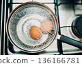 Saucepan stainless steel with boiling eggs breakfast in water on gas stove. 136166781