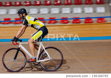 Cyclist Athlete cycling on the cycle track velodrome on bicycle. High quality photo Cyclist Athlete cycling on the cycle track velodrome on bicycle. High quality photo 136166785