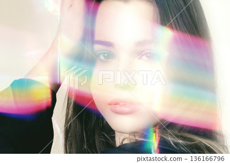 Young woman with colorful rainbow light rays Young woman with colorful rainbow light rays 136166796