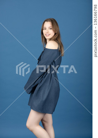 Young woman posing with blue off-shoulder dress Young woman posing with blue off-shoulder dress 136166798