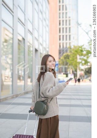 Woman walking with carry bag 136166903
