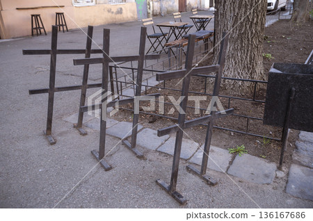 ron racks for parking and securing bicycles near the seating area.  136167686