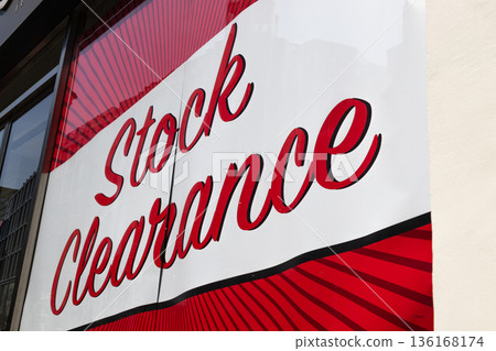 Red stock clearance sign on a retail store window Red stock clearance sign on a retail store window 136168174