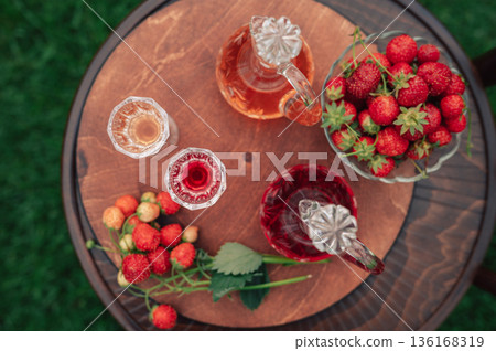 Strawberry Liqueur in Elegant Glass Decanters Outdoors Strawberry Liqueur in Elegant Glass Decanters Outdoors 136168319