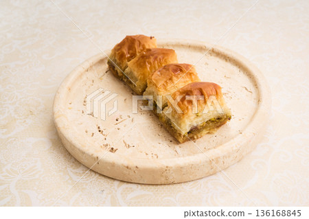 Baklava dessert pieces with pistachio filling on plate 136168845