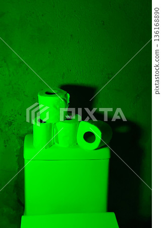 bright green glowing toilet paper rolls in dark spooky bathroom bright green glowing toilet paper rolls in dark spooky bathroom 136168890
