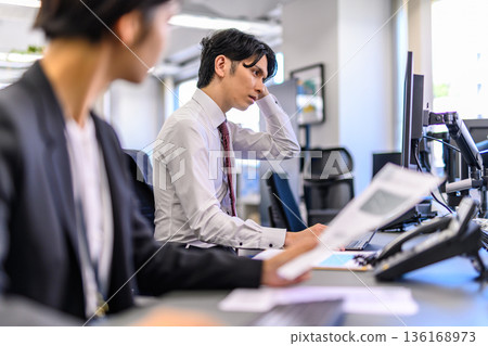 Male employee worried in the office Male employee worried in the office 136168973
