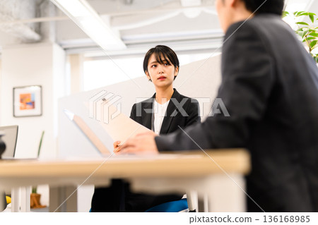 Serious woman at an interview Serious woman at an interview 136168985