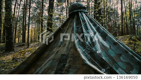WWII German military camp with Zeltbahn tent and ammo crates in forest 136169050