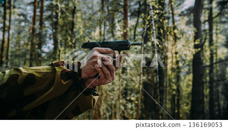Hands of Red Army soviet russian soldier holding empty pistol with slide back in forest reenactment Hands of Red Army soviet russian soldier holding empty pistol with slide back in forest reenactment 136169053