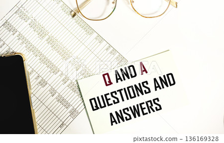 A notebook with the letters Q and A and the text Questions and Answers on documents with numbers 136169328