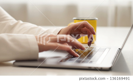 Woman typing on laptop keyboard, representing AI work, remote job, prompt creation, study, freelancing, and research, close-up view. 136169491