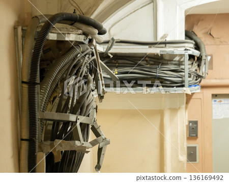 Messy electrical wiring and data cables showing complex infrastructure in an old building 136169492