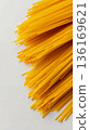 A bunch of spaghetti on a white surface 136169621