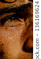 A close up of a man's face with water droplets on his face 136169624