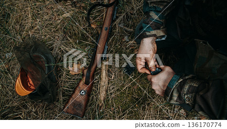 German Soldier hands reloading Mauser rifle with stripper clip during battle simulation 136170774