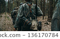Wehrmacht squad marching in single file through forest during WWII patrol Wehrmacht squad marching in single file through forest during WWII patrol 136170784