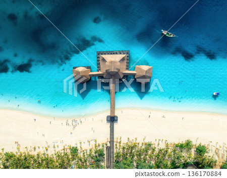 Aerial view of beautiful bungalow and blue sea at sunset. Summer Aerial view of beautiful bungalow and blue sea at sunset. Summer 136170884