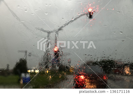 traffic lights on the road during heavy rain 136171116