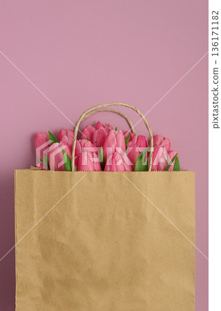 Gift Bag with Pink Tulips on Pink Background. Valentines or Mothers Day Celebration Gift Bag with Pink Tulips on Pink Background. Valentines or Mothers Day Celebration 136171182