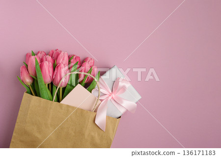 Gift Bag with Pink Tulips and Gift Box on Pink Background. Valentines or Mothers Day Celebration Gift Bag with Pink Tulips and Gift Box on Pink Background. Valentines or Mothers Day Celebration 136171183