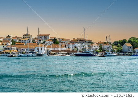 Dalmatian coastal settlement marina with yachts traditional houses and clear Adriatic water in summer Dalmatian coastal settlement marina with yachts traditional houses and clear Adriatic water in summer 136171623