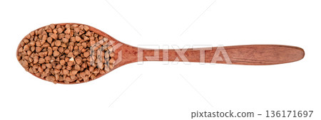 Buckwheat groats in a brown wooden spoon isolated on white background Buckwheat groats in a brown wooden spoon isolated on white background 136171697
