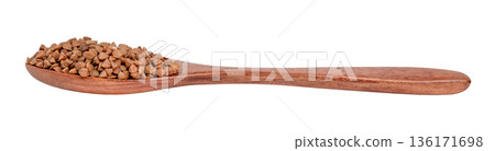 Buckwheat groats in a brown wooden spoon isolated on white background Buckwheat groats in a brown wooden spoon isolated on white background 136171698