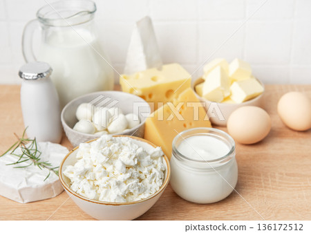 Assorted dairy products and fresh eggs on wooden background Assorted dairy products and fresh eggs on wooden background 136172512
