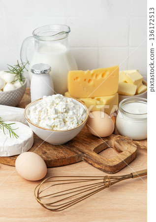 Assortment of fresh dairy products and eggs on wooden board Assortment of fresh dairy products and eggs on wooden board 136172513