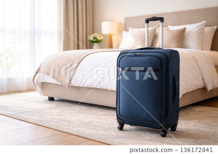 Modern travel suitcase standing in cozy hotel bedroom, vacation and business trip accommodation concept Modern travel suitcase standing in cozy hotel bedroom, vacation and business trip accommodation concept 136172841