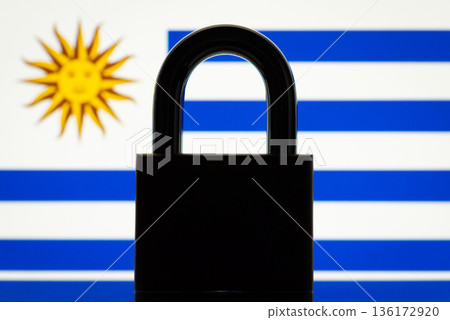 Closed lock and flag of Uruguay. International sanctions, restrictions, closed border of Uruguay concept 136172920