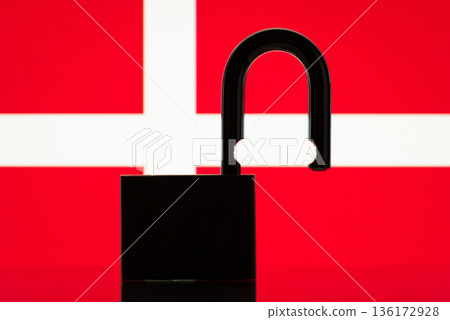 Flag of Denmark behind open lock silhouette. Concept of freedom, end of restrictions, bans, open Denmark country 136172928