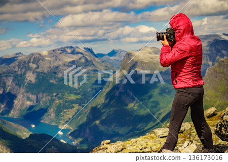 Tourist taking photo from Dalsnibba viewpoint Norway 136173016