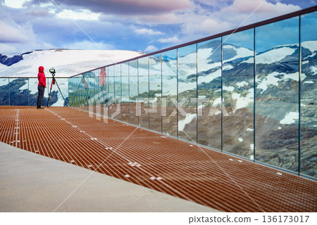 Tourist with camera on tripod in Norway nature 136173017