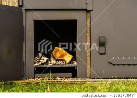 Dark metal stove with wood burning Dark metal stove with wood burning 136173047